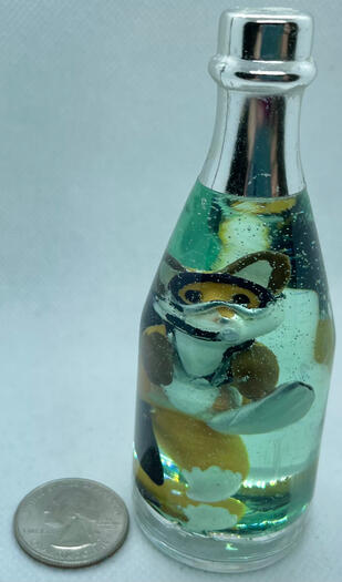 A tiny red fox wearing scuba gear, treading water in a bottle.