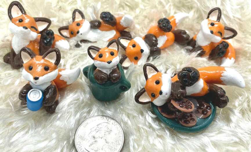 An assortment of tiny polymer clay foxes