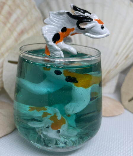 A Koi-Colored Version astern Dragon twists in a glass of azure water while a koi fish friend swims by the tip of his tail